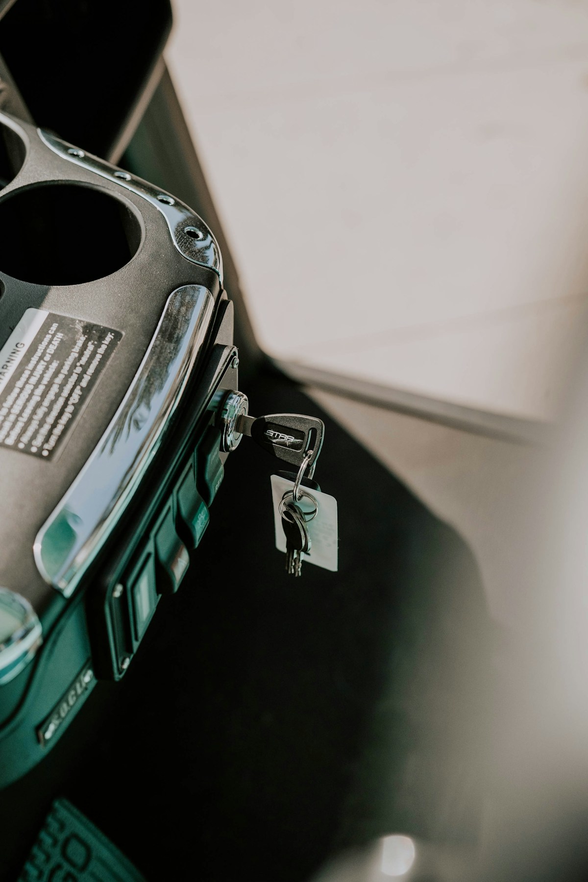 A key left in a vehicle's ignition switch beside the centre console