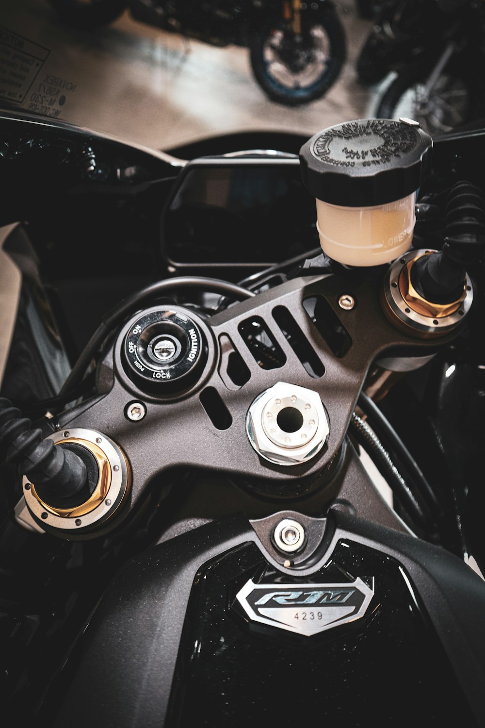 A sportbike's ignition switch set into the top yoke between the handlebars